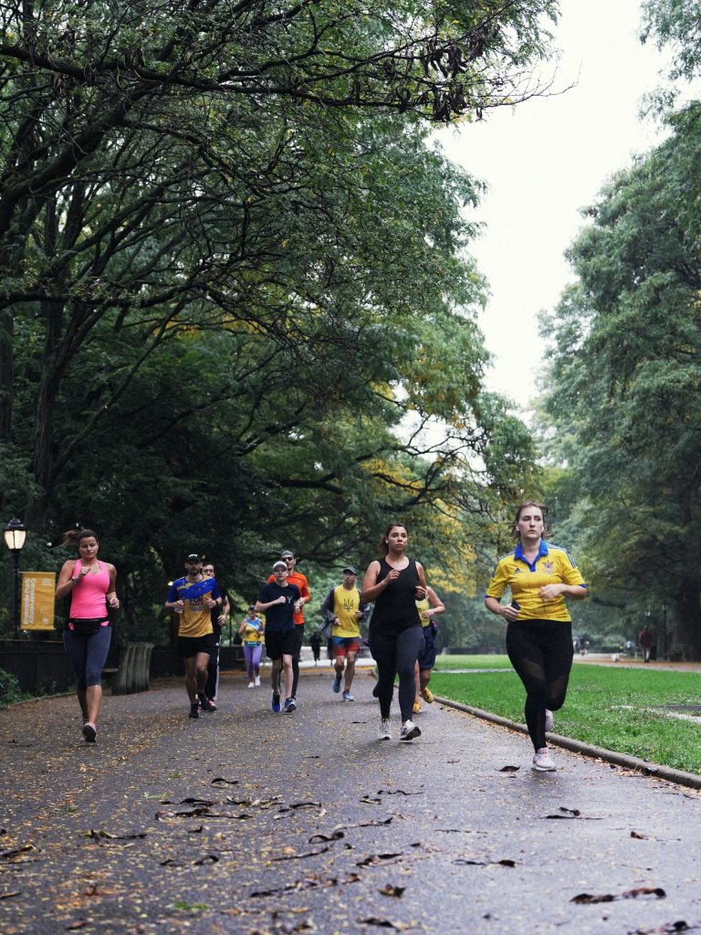 Group of people running on a park path